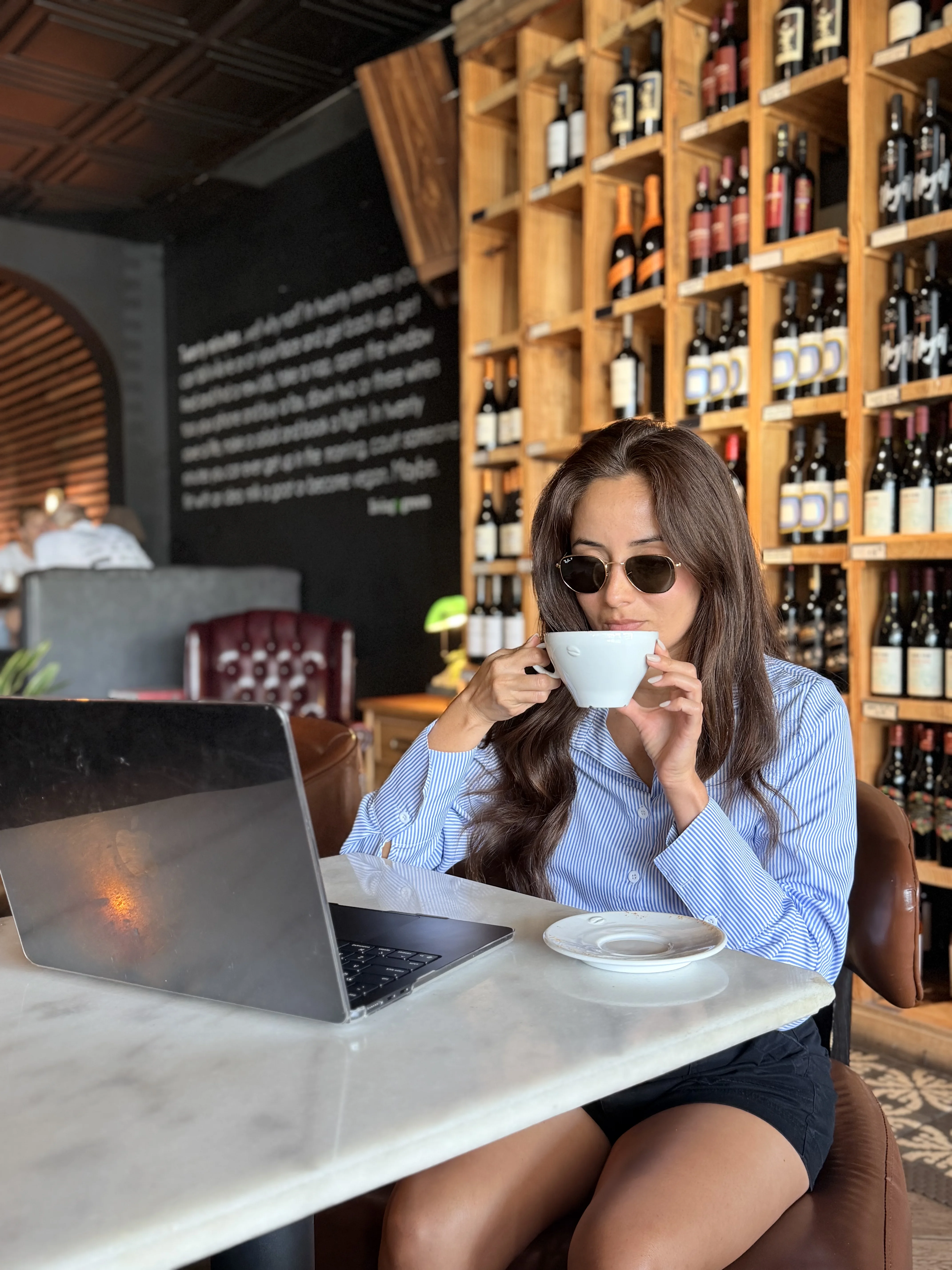 Alexandra DuPont taking a moment with her laptop at a South Florida café