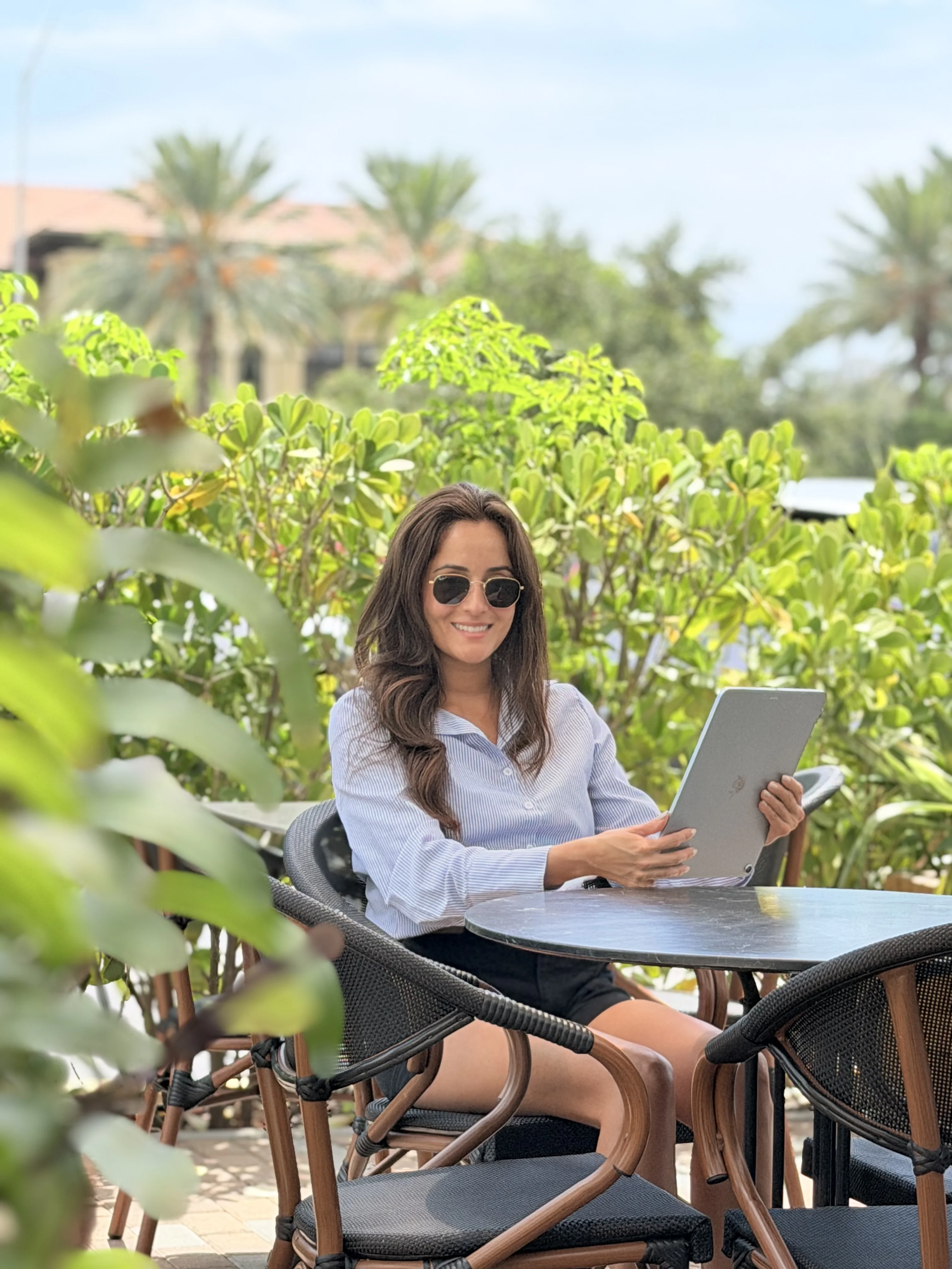 Alexandra DuPont working outdoors with a tablet in South Florida